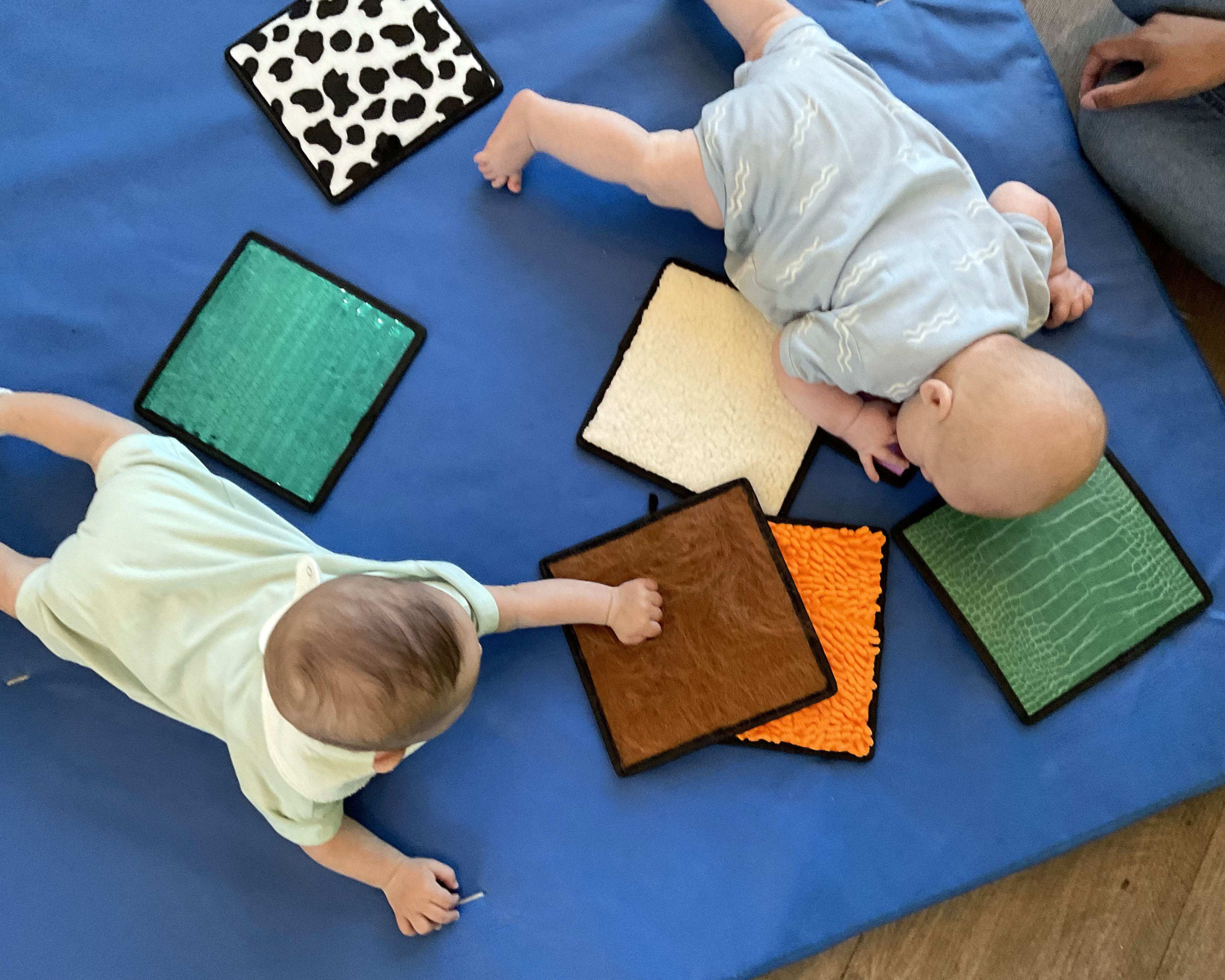 Infants exploring textured tiles