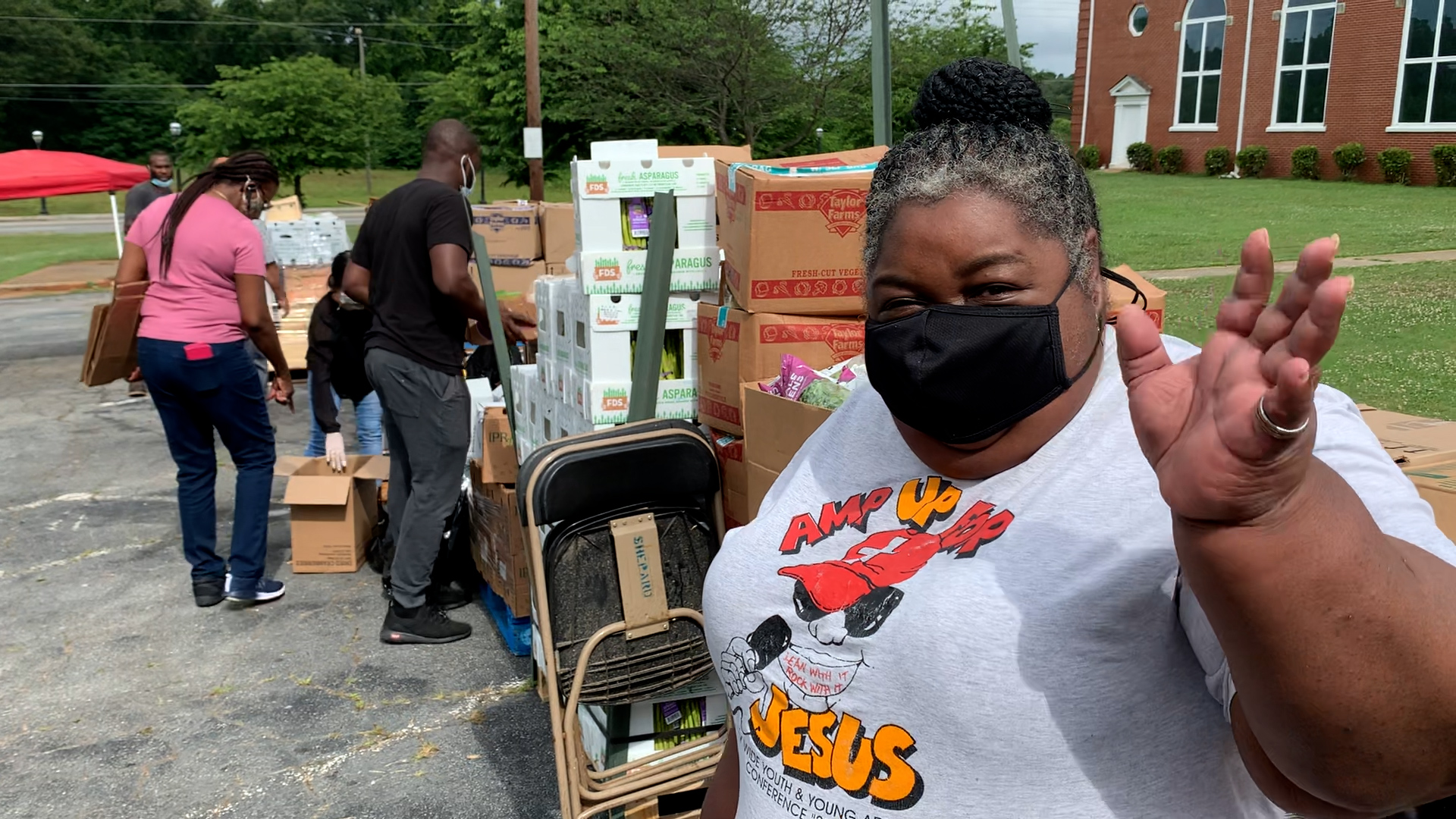 Adult participant and staff volunteering with LEAF food bank